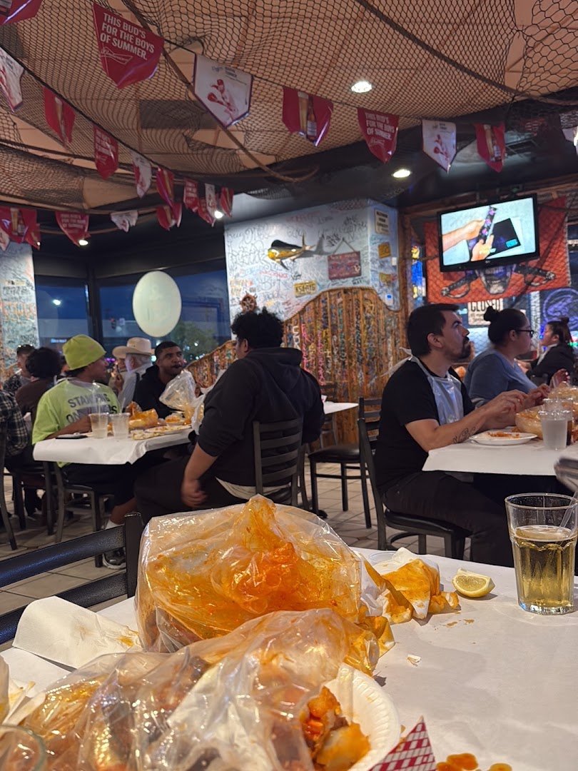 Boats and marine decor inside a seafood spot.